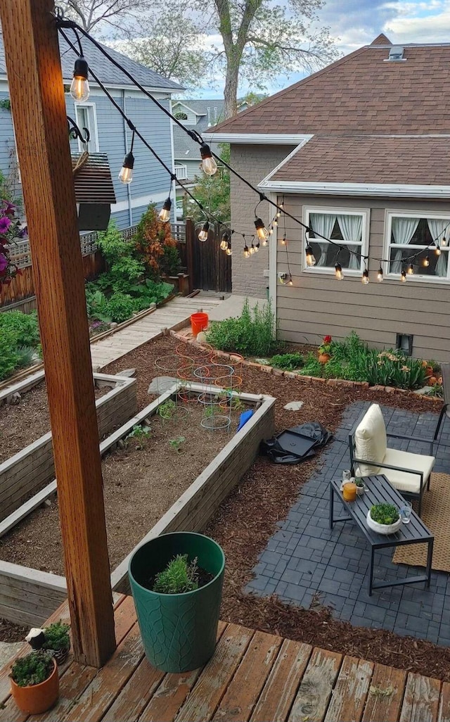 view of yard featuring a patio, fence, and a garden