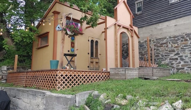 back of property featuring stucco siding