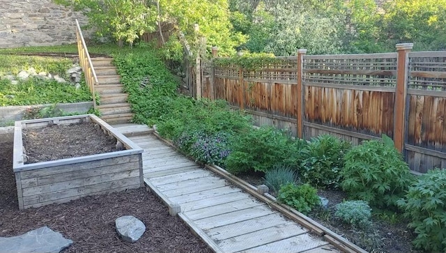 view of yard with stairs and fence