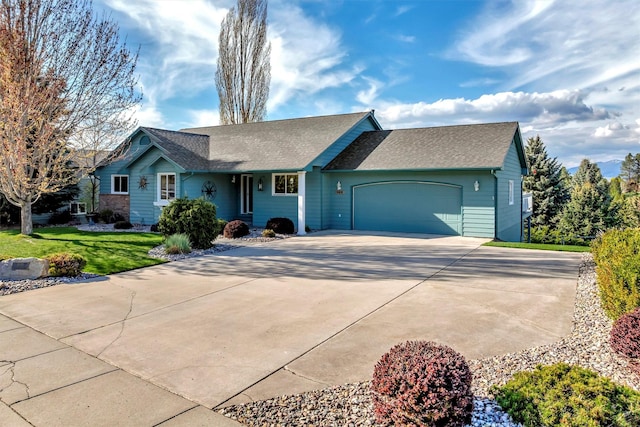 ranch-style house with concrete driveway, a front yard, an attached garage, and roof with shingles