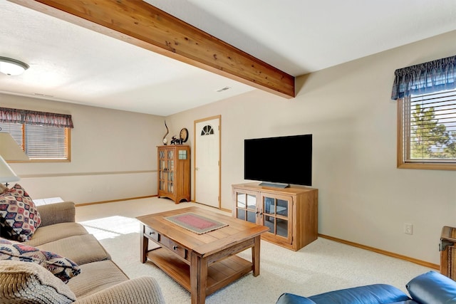 living room with baseboards, carpet flooring, beam ceiling, and visible vents