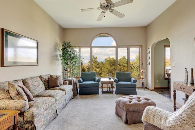 living room with arched walkways and ceiling fan
