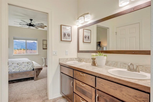full bathroom featuring a sink, a ceiling fan, double vanity, and connected bathroom