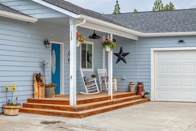 118 Rambling River Rd, Stevensville, MT 59870 - ranch-style home with an attached garage, a porch, a mountain view, and driveway