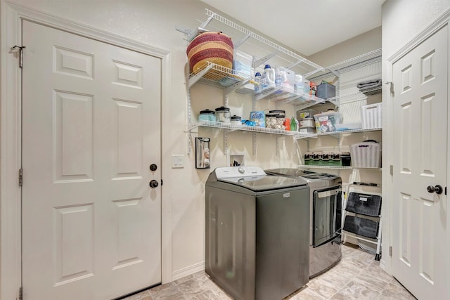clothes washing area with laundry area and washing machine and clothes dryer
