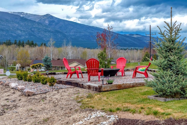 view of jungle gym with a fire pit and a mountain view