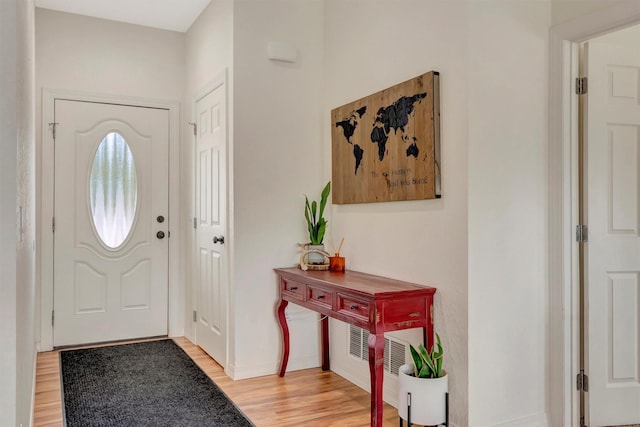 foyer featuring baseboards and light wood finished floors