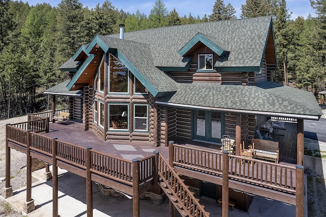 550 Jackson Meadows Rd, Kila, MT 59920 - rear view of property featuring log siding, a shingled roof, french doors, a wooden deck, and stairway