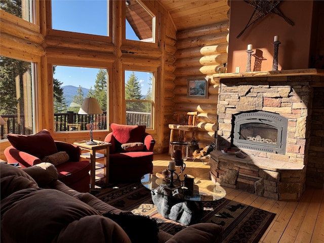living room featuring rustic walls, high vaulted ceiling, hardwood / wood-style flooring, and a fireplace
