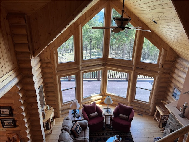 living room featuring high vaulted ceiling, wooden ceiling, log walls, and hardwood / wood-style flooring