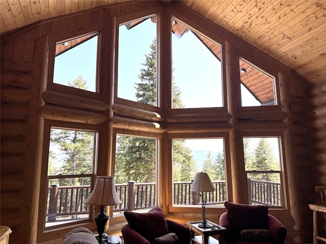 living room featuring rustic walls, wooden ceiling, a healthy amount of sunlight, and lofted ceiling