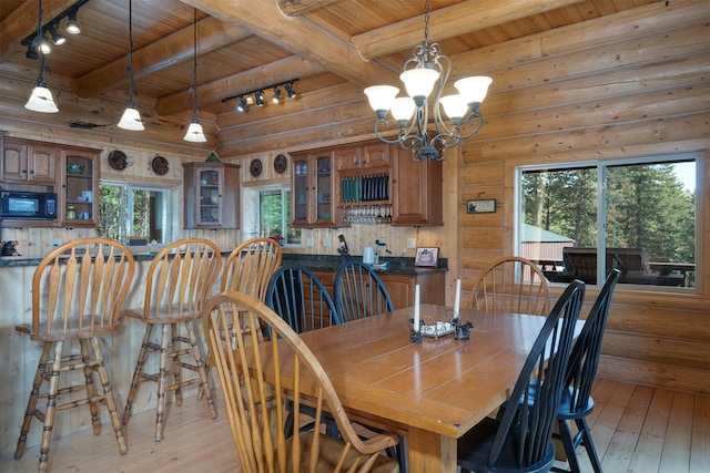 550 Jackson Meadows Rd, Kila, MT 59920 - dining space with wood ceiling, rail lighting, light wood finished floors, a chandelier, and beamed ceiling