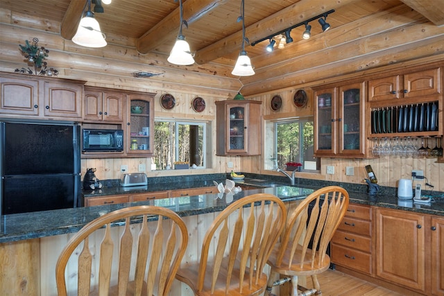 550 Jackson Meadows Rd, Kila, MT 59920 - kitchen with black appliances, wooden ceiling, brown cabinets, light wood-style floors, and decorative light fixtures