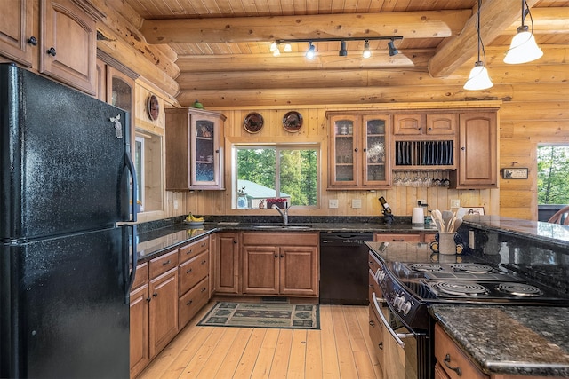 550 Jackson Meadows Rd, Kila, MT 59920 - kitchen featuring black appliances, light wood-style flooring, brown cabinets, glass insert cabinets, and a wooden ceiling with exposed beams
