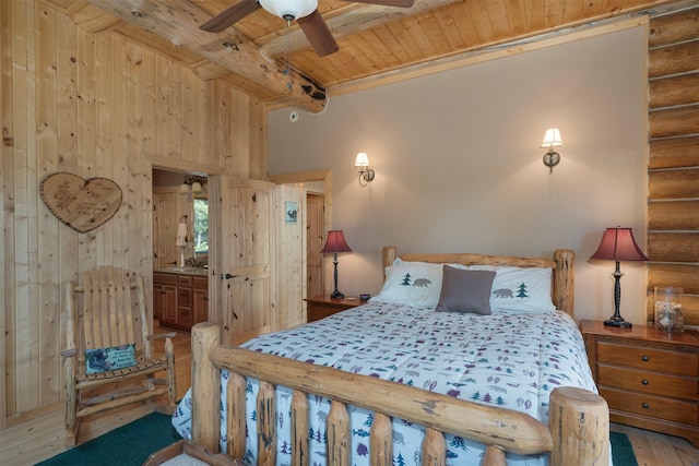 550 Jackson Meadows Rd, Kila, MT 59920 - bedroom featuring wooden ceiling, rustic walls, wood-type flooring, beamed ceiling, and ceiling fan
