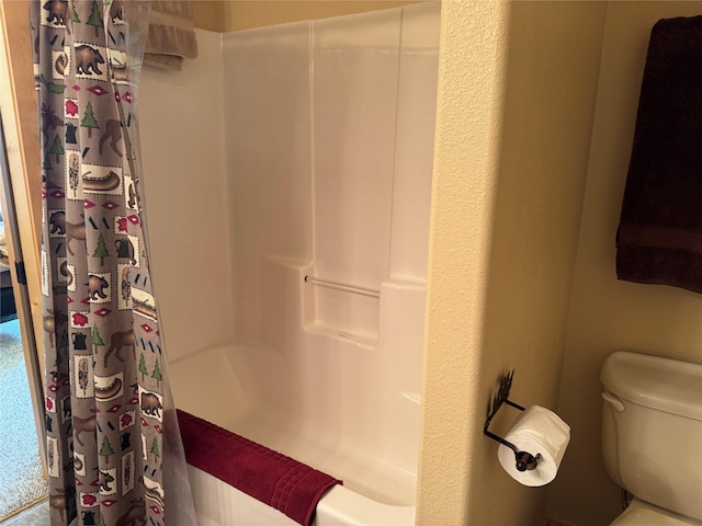 bathroom with toilet and curtained shower