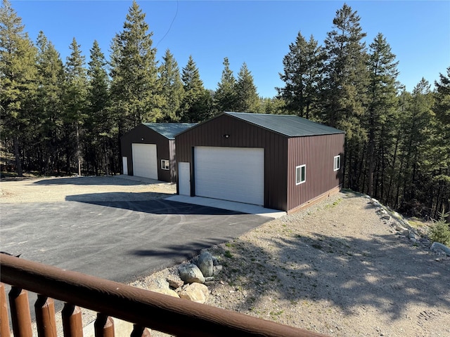 detached garage with a forest view