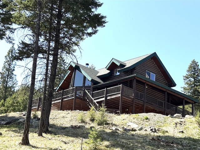 view of property exterior featuring a shingled roof