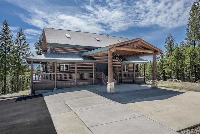 550 Jackson Meadows Rd, Kila, MT 59920 - view of front of home with covered porch, roof with shingles, and driveway