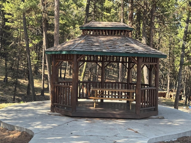 view of property's community with a view of trees and a gazebo