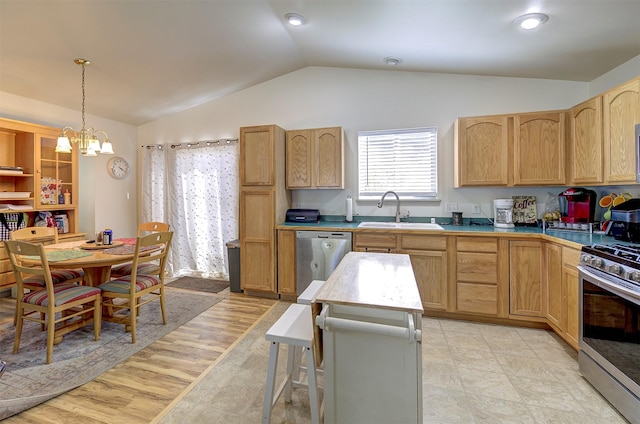 2603 Quinn Ct, Missoula, MT 59804 - kitchen featuring decorative light fixtures, lofted ceiling, a sink, a chandelier, and stainless steel appliances