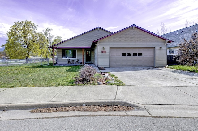 2603 Quinn Ct, Missoula, MT 59804 - ranch-style home featuring a front lawn, fence, an attached garage, driveway, and a porch