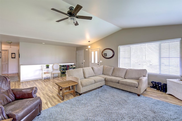 living area featuring ceiling fan, wood finished floors, and lofted ceiling