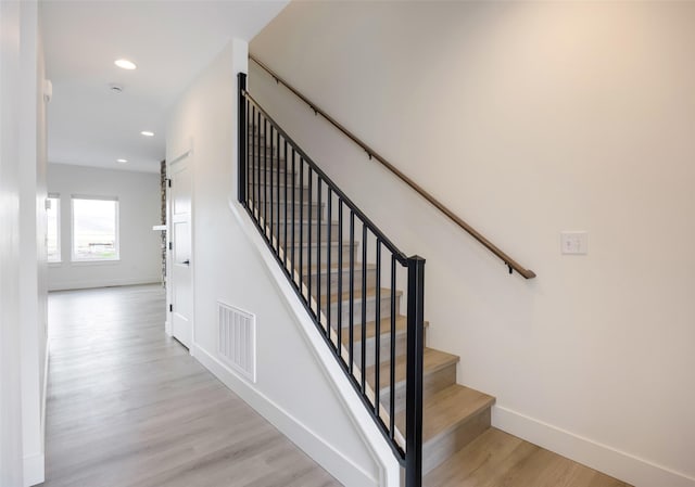 stairway with visible vents, recessed lighting, baseboards, and wood finished floors
