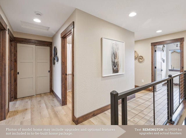 hallway featuring recessed lighting, baseboards, and light wood-type flooring