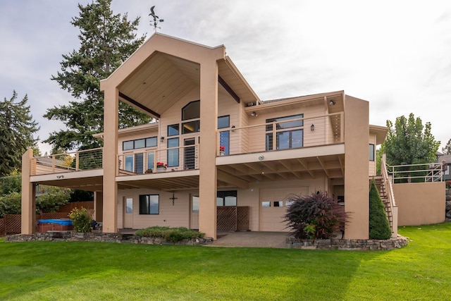 rear view of property featuring a yard, stairway, and a balcony