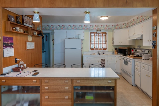 kitchen featuring white appliances, white cabinetry, under cabinet range hood, and light countertops