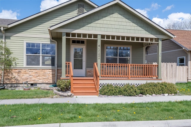 view of front of house with covered porch and stone siding