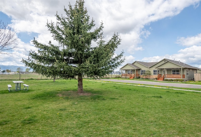 exterior space with a porch and a front lawn