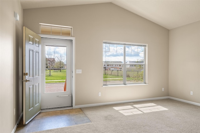 doorway featuring baseboards, carpet, and lofted ceiling