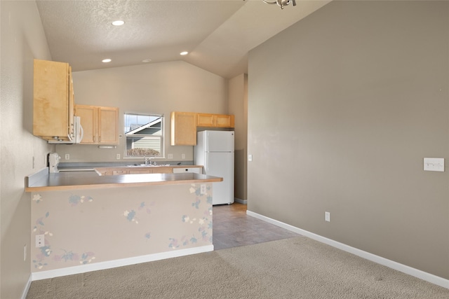 kitchen with a sink, baseboards, light brown cabinets, light carpet, and white appliances