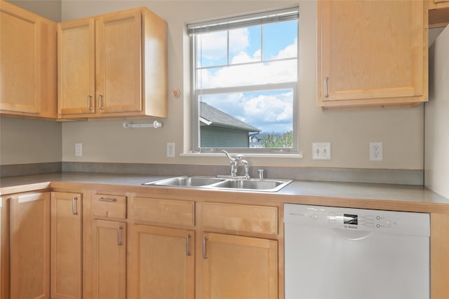 kitchen with white dishwasher, a sink, light brown cabinets, and light countertops