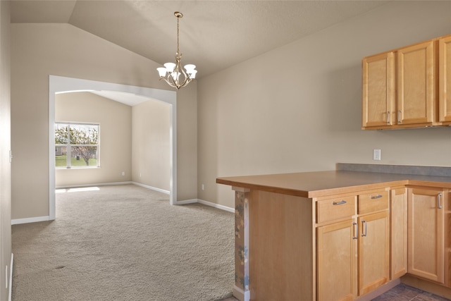 4112A Geary Ln Unit A, Missoula, MT 59808 - kitchen featuring arched walkways, a chandelier, light brown cabinets, carpet, and lofted ceiling