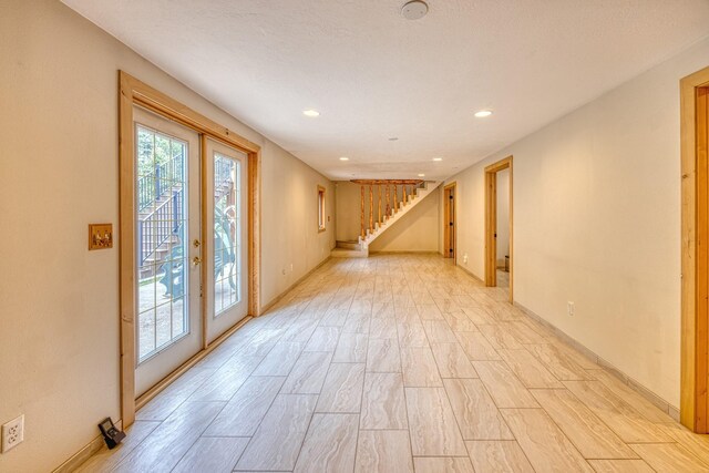 basement with light wood-type flooring, stairway, recessed lighting, and baseboards