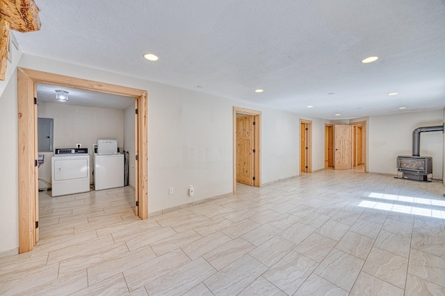 finished basement with a wood stove, independent washer and dryer, and recessed lighting