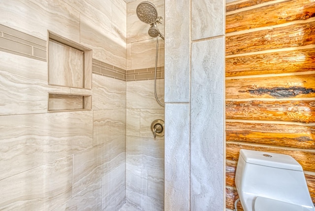 bathroom with toilet and tiled shower