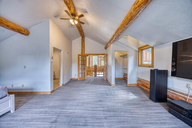 unfurnished living room with carpet flooring, lofted ceiling with beams, ceiling fan, and baseboards