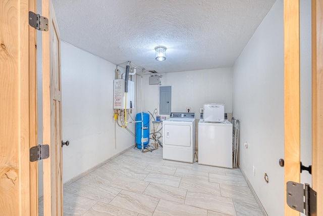 laundry room featuring washing machine and dryer, a textured ceiling, electric panel, laundry area, and water heater
