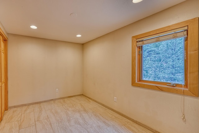 empty room with baseboards and recessed lighting