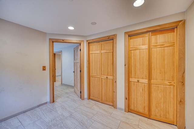 corridor with baseboards and recessed lighting
