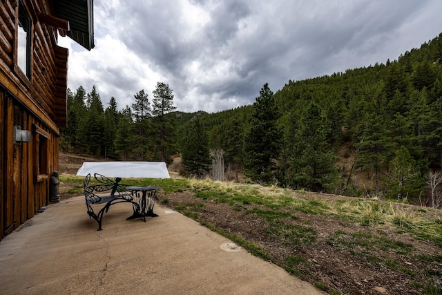 view of patio / terrace with a view of trees