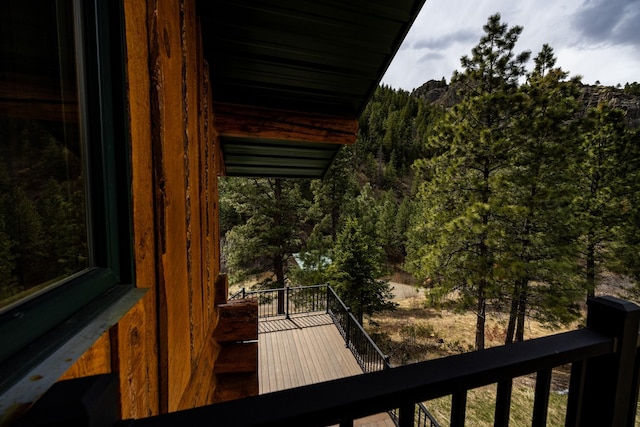 balcony featuring a view of trees