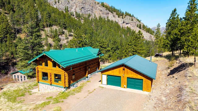 aerial view with a wooded view and a mountain view