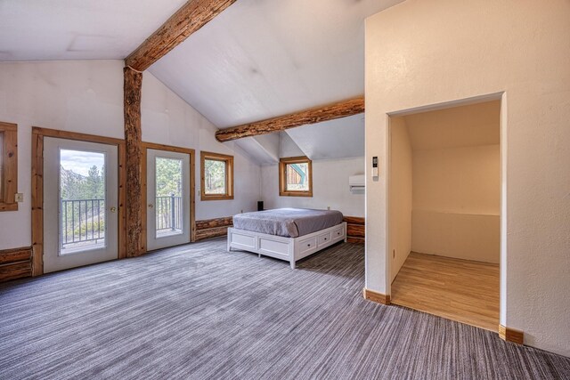bedroom with carpet flooring, vaulted ceiling with beams, and access to exterior