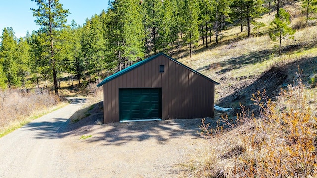 detached garage with dirt driveway