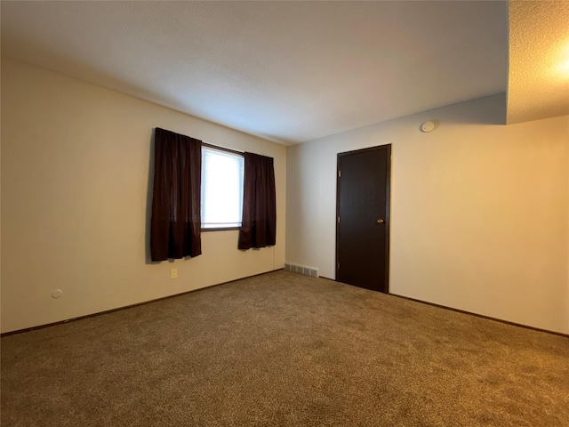 unfurnished room featuring visible vents and carpet
